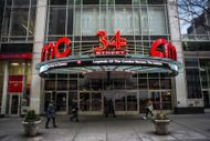 People walking past an AMC theater - Source: Getty